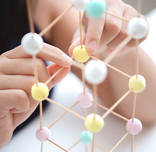 Closeup of student building a molecule structure